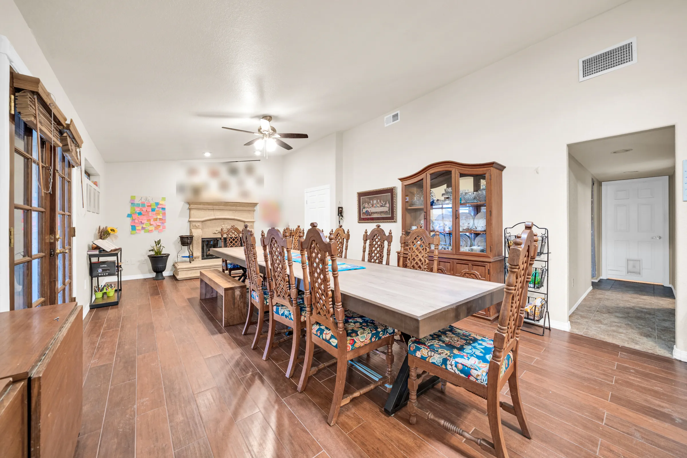 The long wooden dining table in the host family's house, set about with carved chairs, in a bright room with a fireplace.